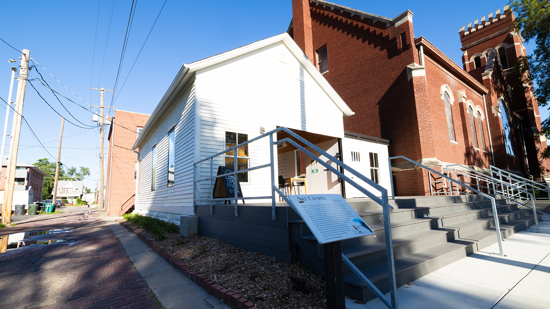 The exterior of the newly remodeled Art Chapel, located on the north side of the F Street Neighborhood Church. The 1873 structure served as one of Lincoln's earliest churches and has gone through several iterations before becoming a community creative space. The building was remodeled by a team of University of Nebraska–Lincoln architecture students, in partnership with local contractors and the church.
