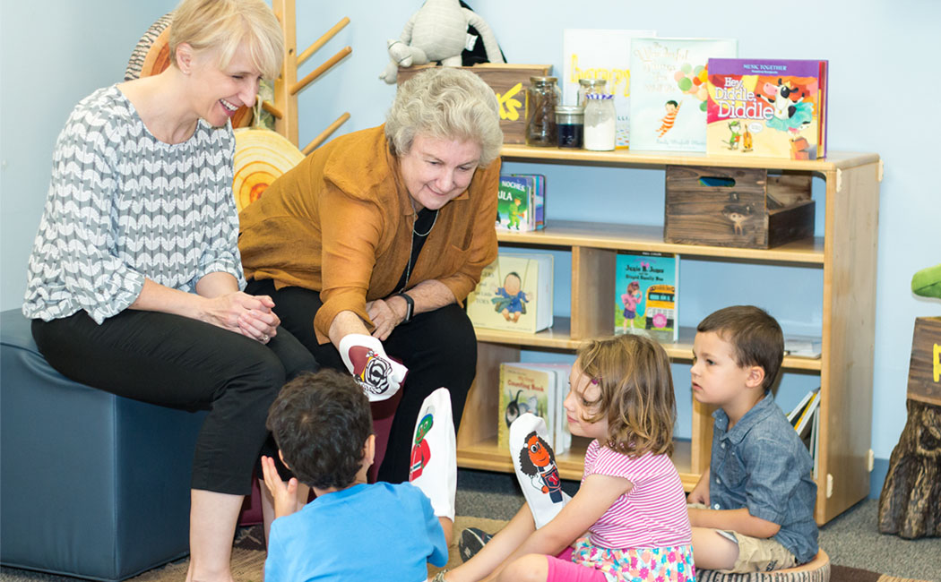 From right, Gwen Nugent, CYFS research professor, and Kathleen Rudasill, professor of educational psychology and associate dean for research and faculty development at Virginia Commonwealth University, introduce children to a few of the puppet characters 