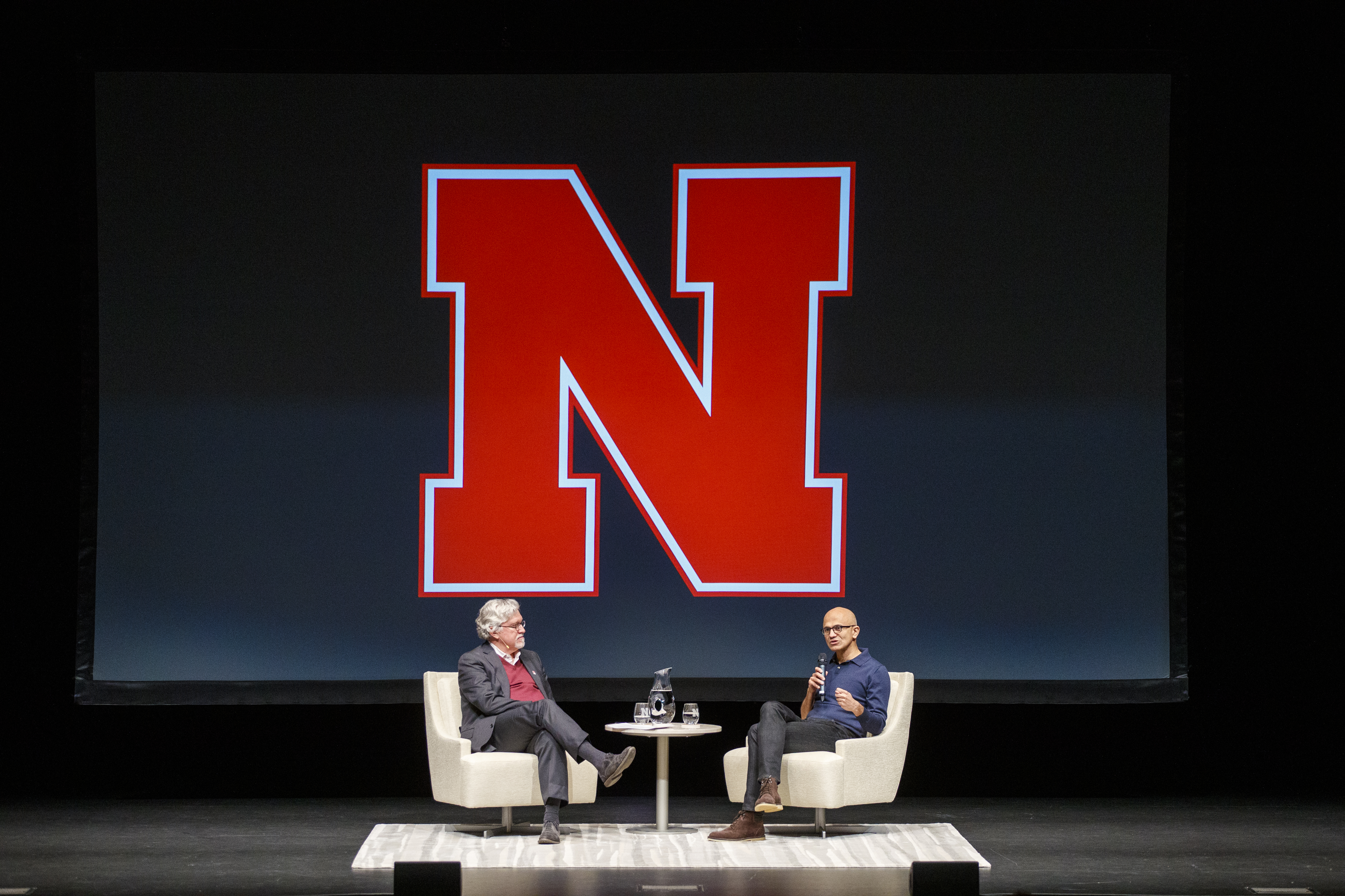 Microsoft CEO Satya Nadella (right) talks with Jeffrey S. Raikes at the Lied Center for Performing Arts on April 18. Nearly 1,000 attended the N150 event.