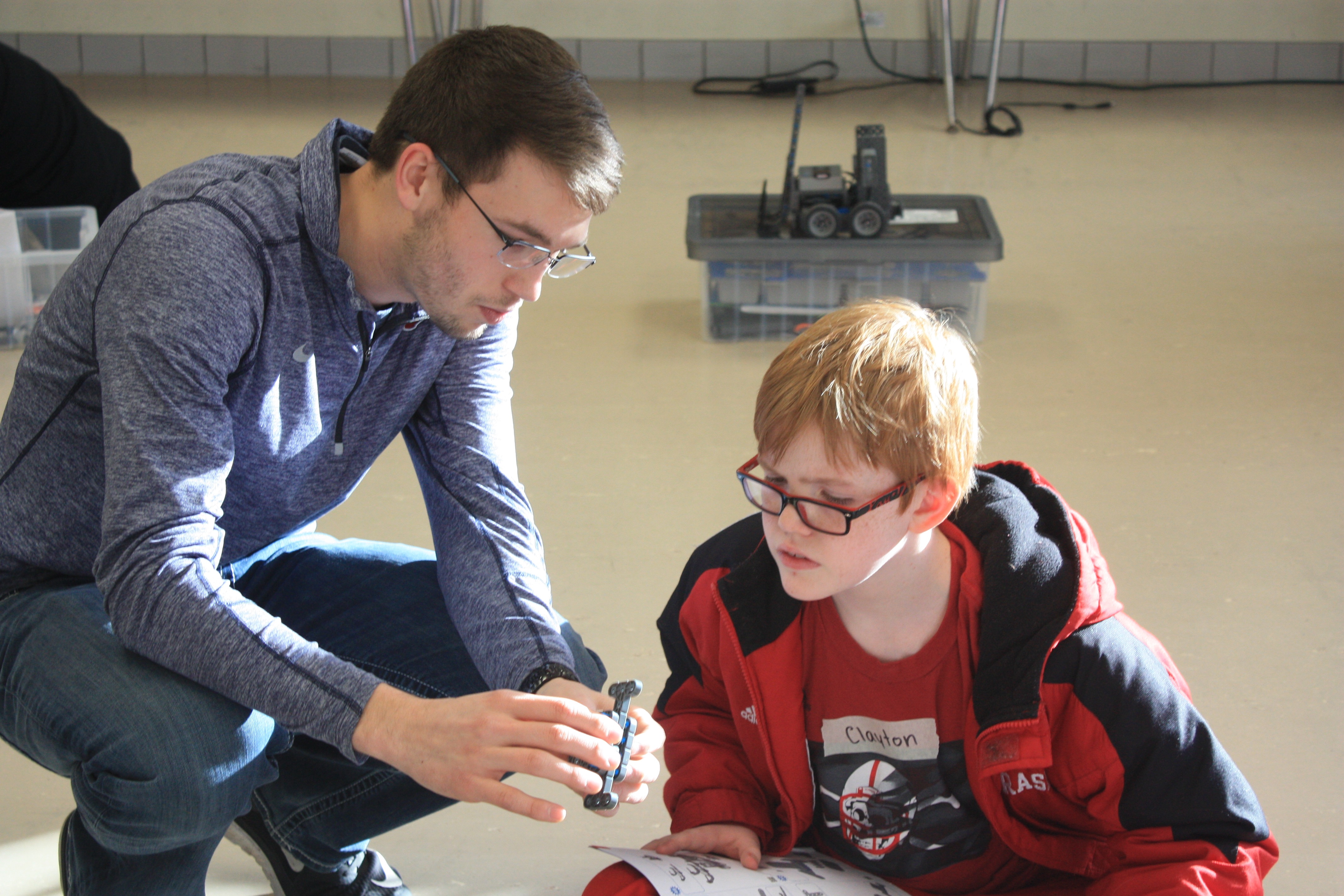 Nebraska student Colton Harper mentors a student at Culler Middle School as part of a robotics club formed in January.