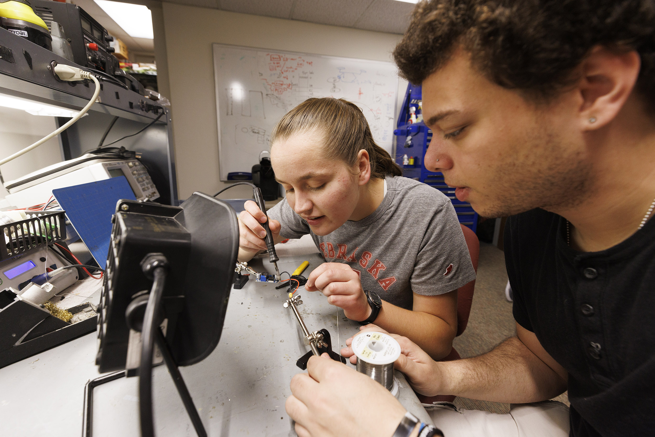 Students building components for a robot.