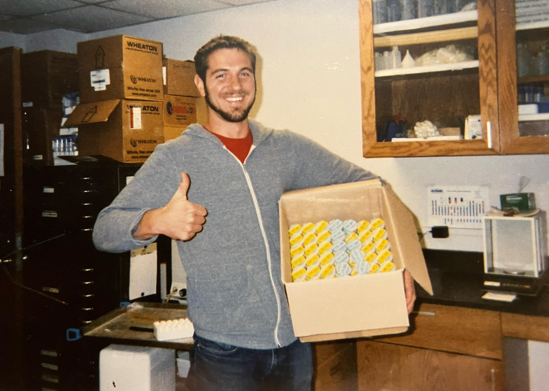 Jim Benes gives a thumbs-up while holding a box in a lab in this 2012 photo.