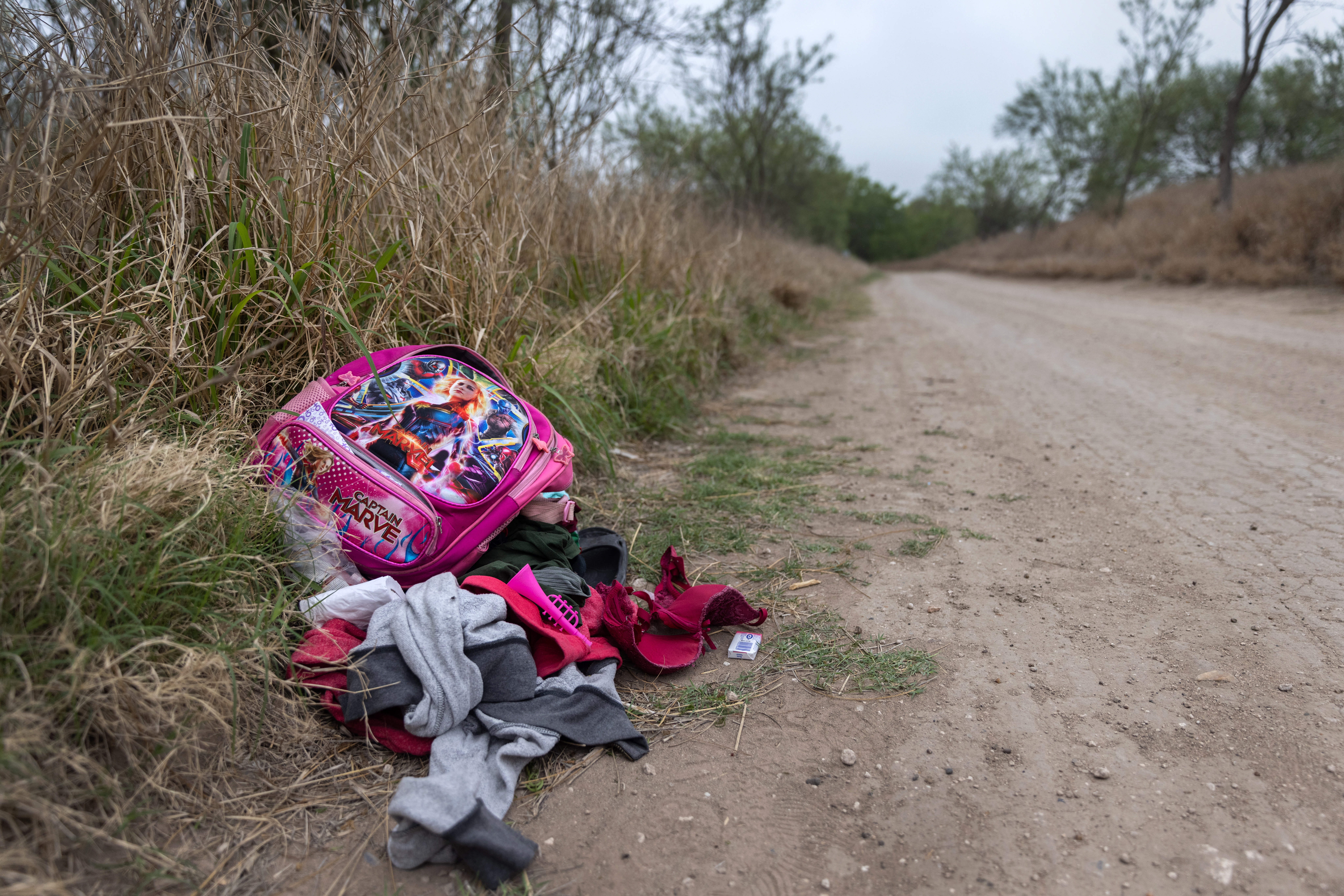 A child’s abandoned backpack and clothing lie near an illegal river crossing point at the U.S.-Mexico border on March 24, 2021, near McAllen, Texas.