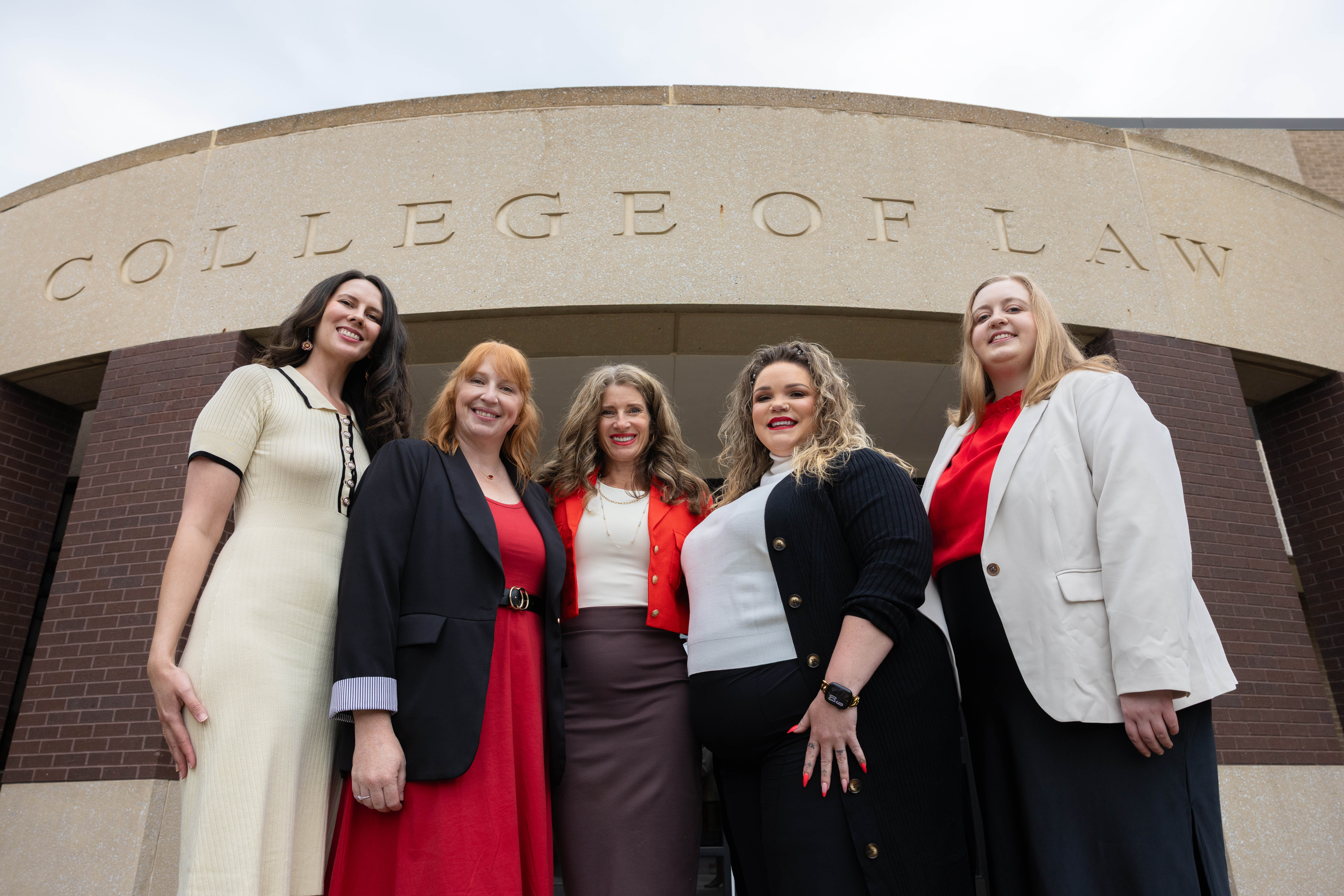 The staff of the Nebraska Children's Justice and Legal Advocacy Center stand outside McCollum Hall in June. They include (from left) Terra Garay, program coordinator; Lori Miller, paralegal; Michelle Paxton, director and assistant professor of law; Megan Harris, mental health consultant; and Hannah Cook, associate director.
