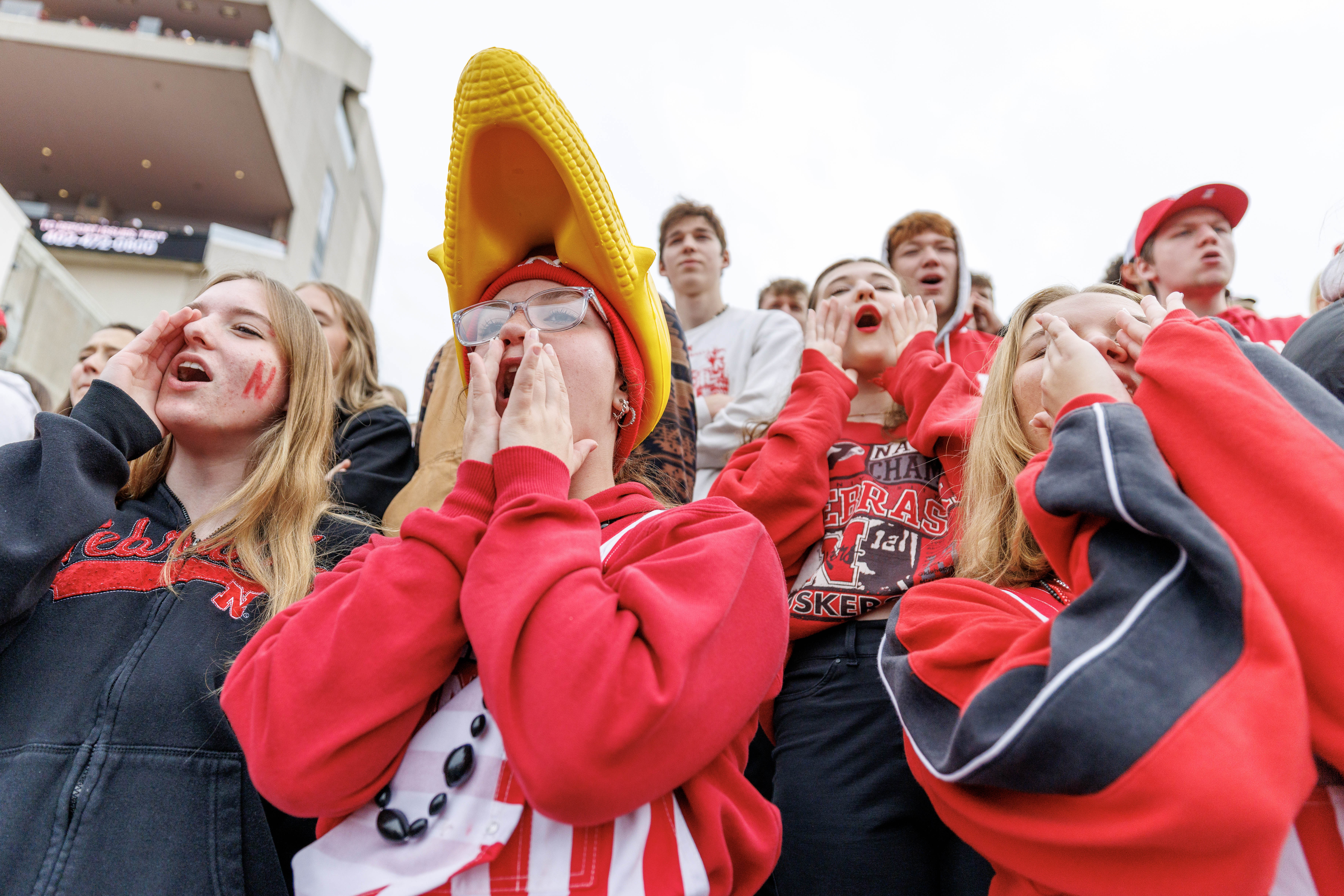 Husker fans (from left) Audrey Hutchinson, Brooklynne Costello and Kailee Eisma cheer during the first quarter of the Nebraska-UCLA game Nov. 2, 2024, at Memorial Stadium.