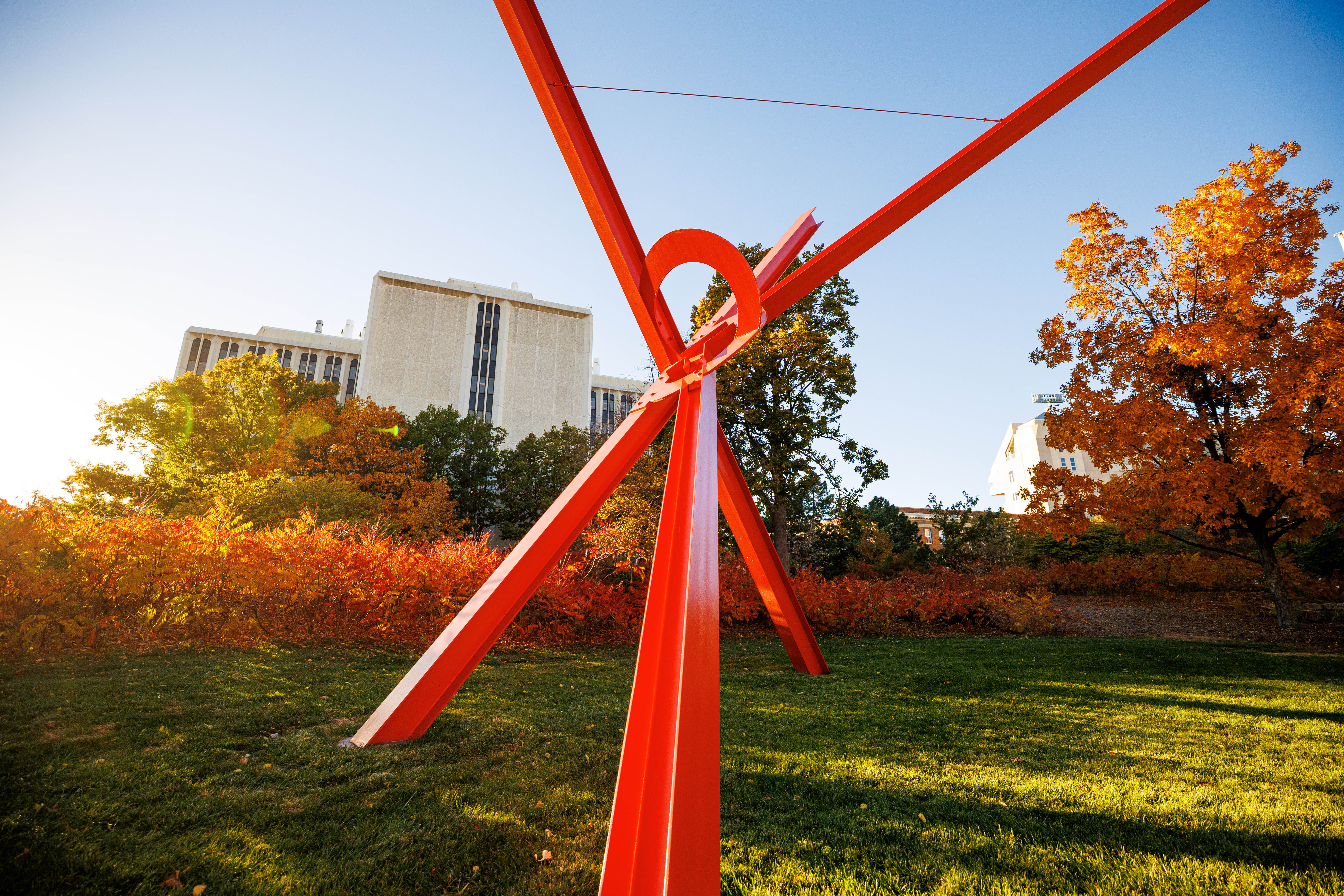 A close-up of "Old Glory" — a giant sculpture with red steel beams — on a fall day.