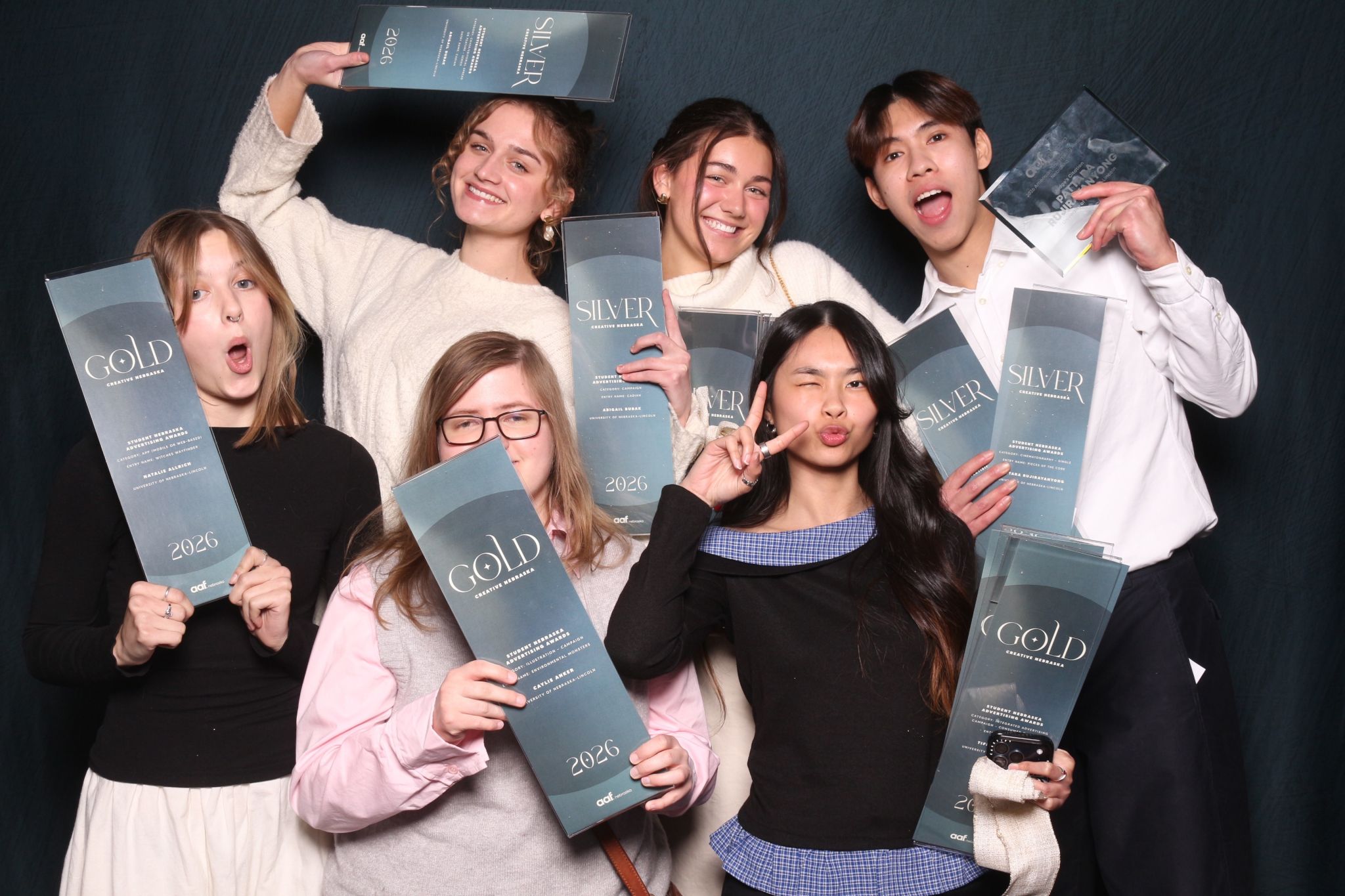 Graphic design students pose with awards. Clockwise from upper left, they are: Abigail Bubak, Clare Clark, Pattara Rujirayanyong, Tiffany Nguyen, Caylie Anker and Natalie Allrich.