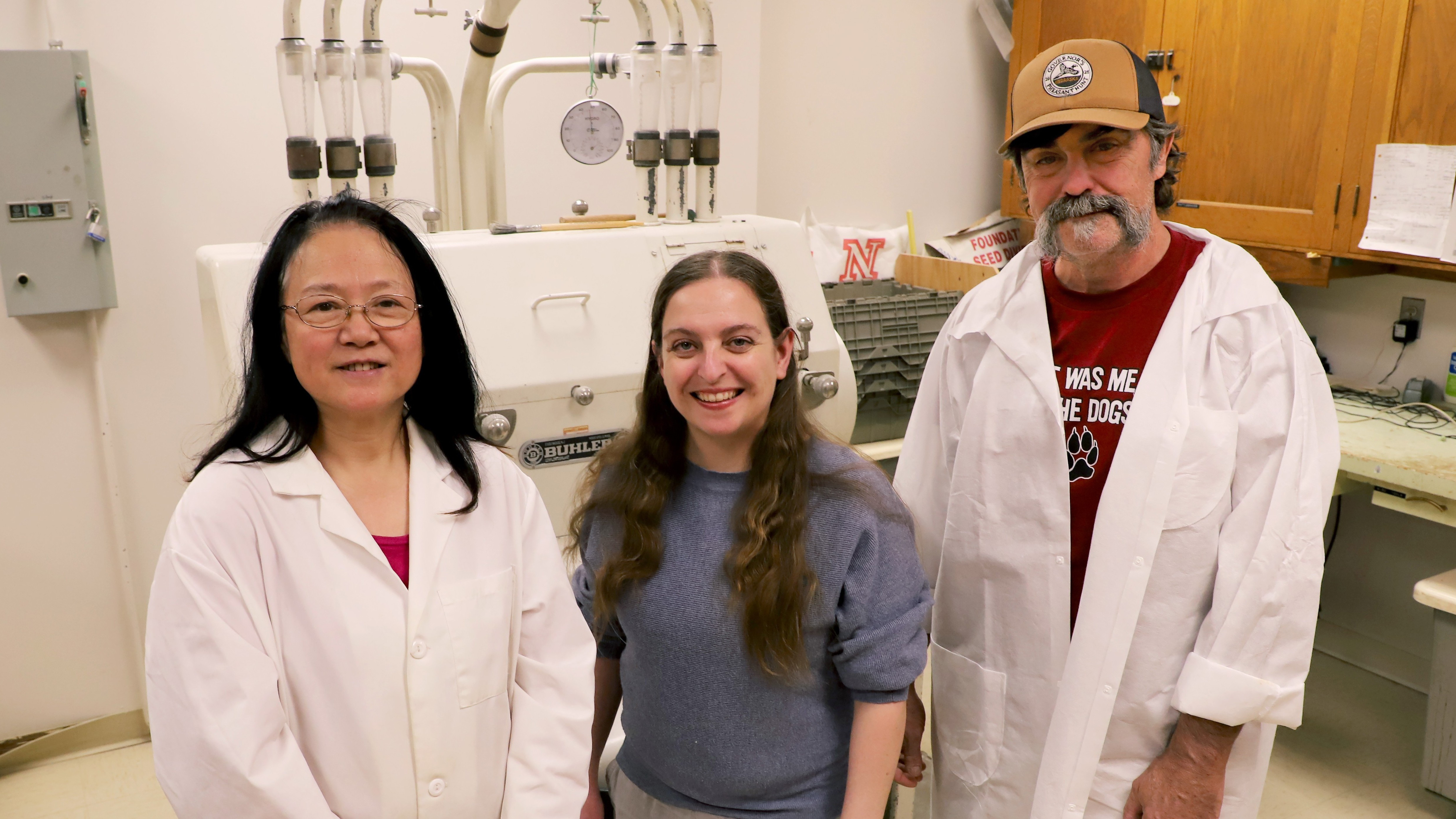 Two women and a man pose in a lab.