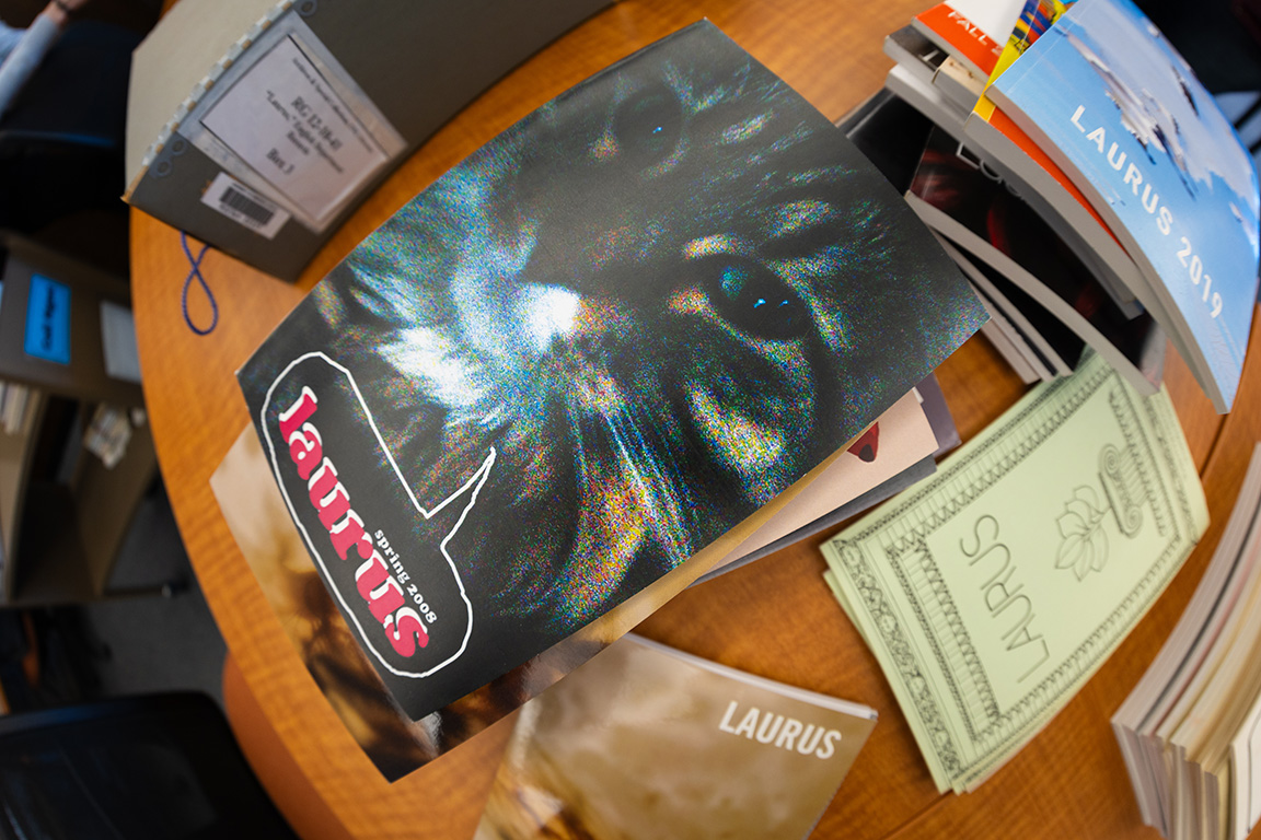copy of the spring 2008 issue of Laurus, the student-produced literature and art journal, rests at the top of a pile of journals being digitized by staff and students at Love Library.