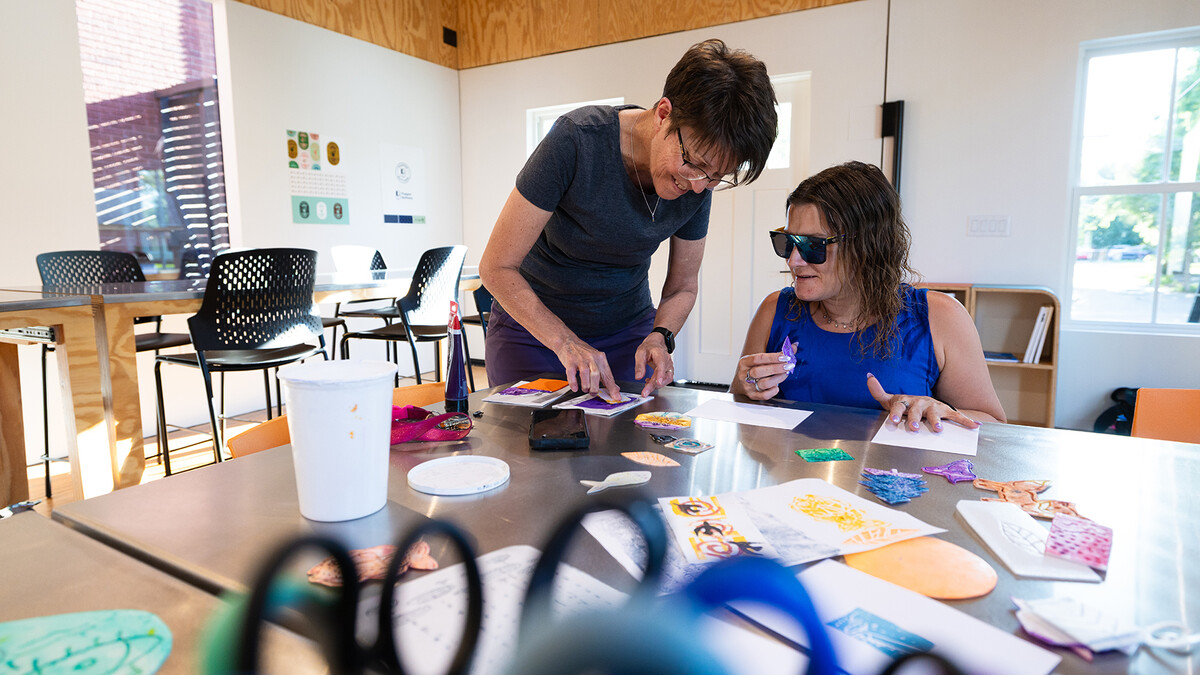 Jean Stryker (left) shows Jessica Hernandez how to dip a stamp into paint for a printmaking activity at the Art Chapel on June 30. The Art Chapel is part of the church's community outreach, providing an accessible space for people to pursue creativity at no to low cost. Open studio time is available from 6 to 9 p.m. each Monday at the chapel.