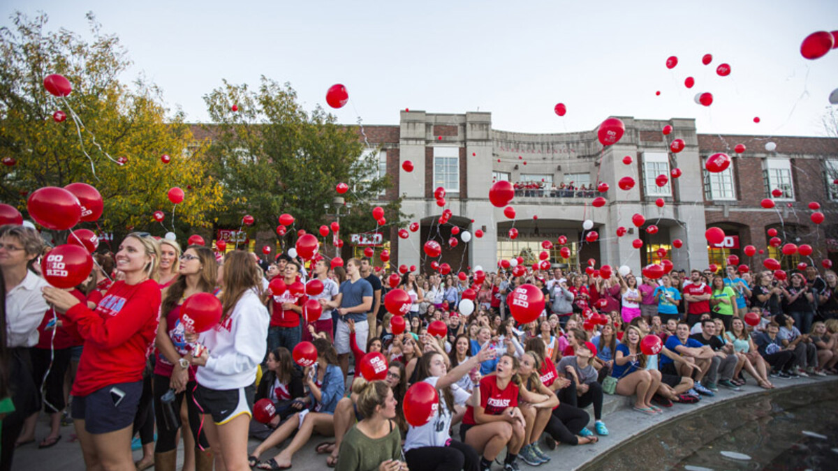 Husker fans release balloons during the Oct. 4 UNL Homecoming pep rally on the Nebraska Union Plaza.