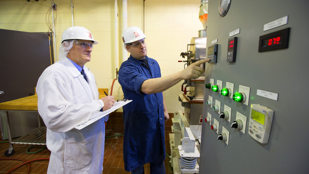 Biological Systems Engineering Professor Curtis Weller and Steve Weier, FPC Pilot Plant manager, look over equipment.