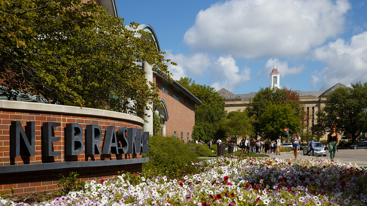 Nebraska students walk by the Van Brunt Visitors Center on 13th Street. Also pictured in the background is Love Library.