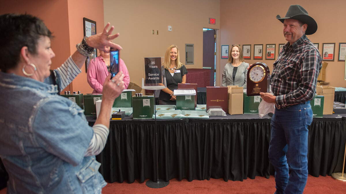 Michael Wilford (right) of the U.S. Meat Animal Research Center, poses for a photo with his 35-year Service Award prior to the start of the Celebration of Service. Award winners picked up their honors and attended a reception in the Lied Center for Performing Arts.