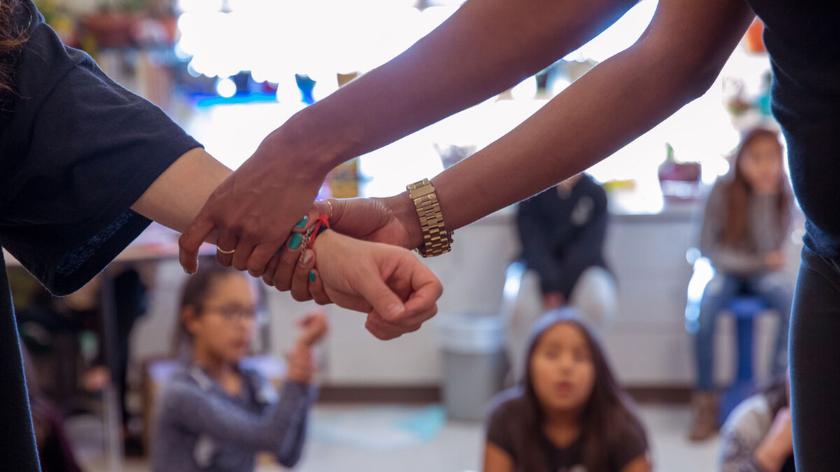 Instructors work with children on a Native American reservation as part of the IMpower violence prevention program. (Photo courtesy of Brooke Duthie Photography)