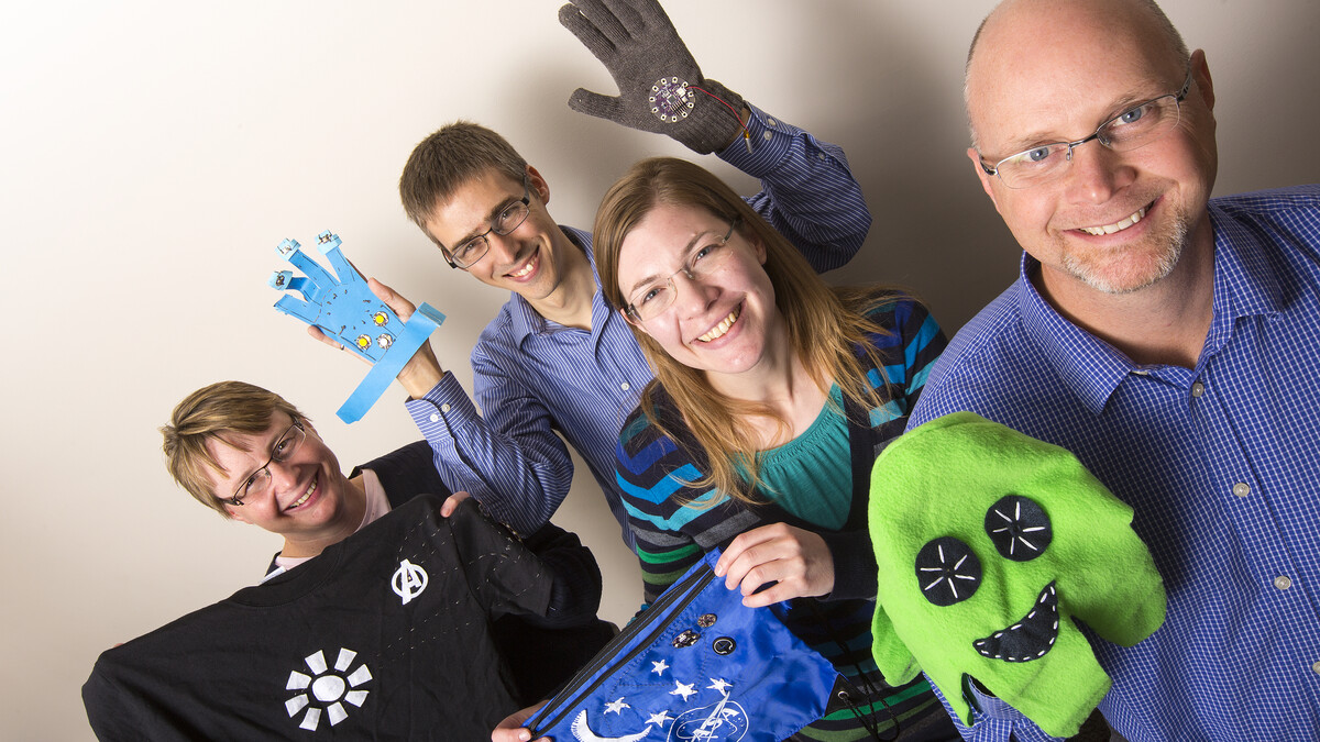 Brad Barker, right, Jennifer Melander, Carl Nelson and Michelle Krehbiel show off examples of wearable tech that are designed by 4-H students using micro-controllers.