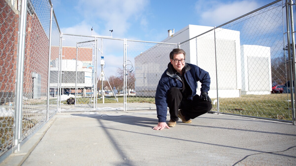 Chris Tuan, professor of civil engineering at the University of Nebraska-Lincoln, stands on a slab of conductive concrete that can carry enough electrical current to melt ice during winter storms. Tuan is working with the Federal Aviation Administration and U.S. Strategic Command on multiple applications for his patented concrete mixture.