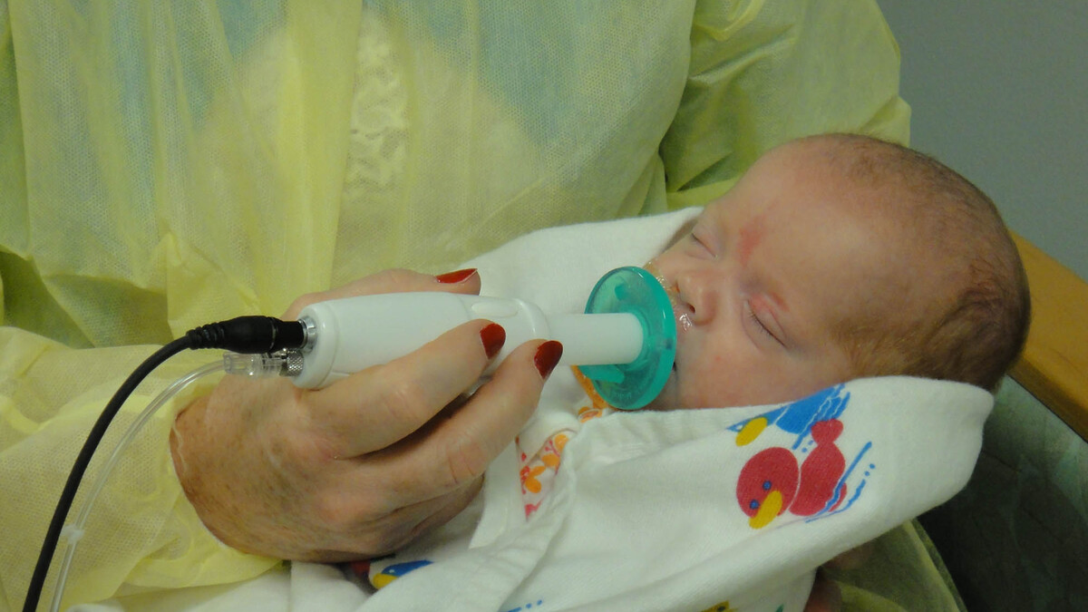 An infant uses the NTrainer System, a therapy device developed by UNL's Steven Barlow to stimulate early development of essential feeding skills in preterm infants.