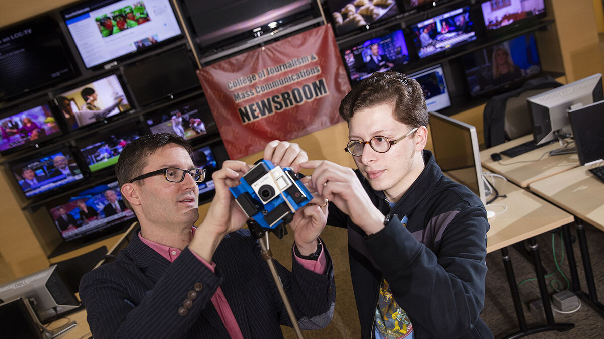 Matt Waite, left, professor of practice in UNL's College of Journalism and Mass Communications, and Tony Papousek, a senior journalism major from Clarkson, created a 360 video of the Beatrice 77 sale barn during a live auction.