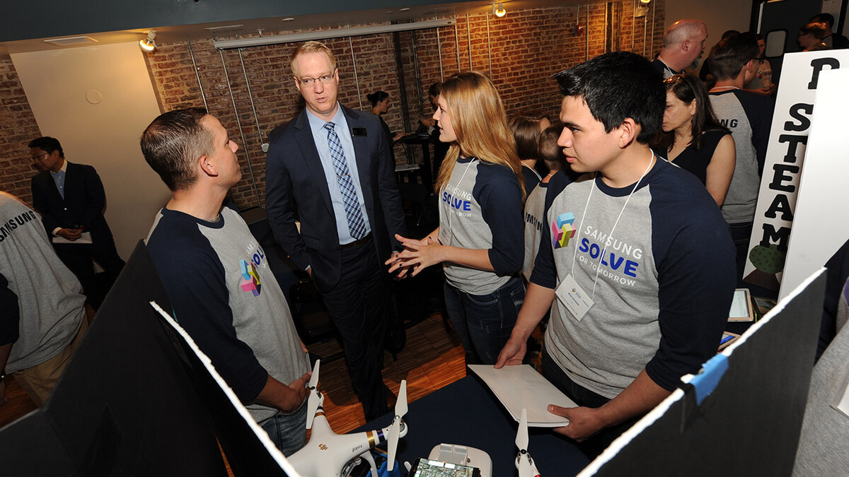 (From left) Justin Reinmuth, judge Elliot Mork of Project Lead the Way, Elexus Johnson and Eric Crane.