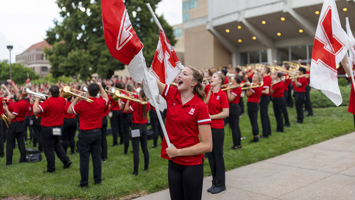 Color guard member Haley Petri chants “Go Big Red” during the Cornhusker Marching Band’s warm-up concert north of Kimball Recital Hall on Aug. 20. The band then marched to Memorial Stadium for its annual exhibition before it was canceled due to lightning. The band will make its 2021 debut Sept. 4 at the stadium with pregame and halftime performances at Nebraska's football home opener against Fordham.