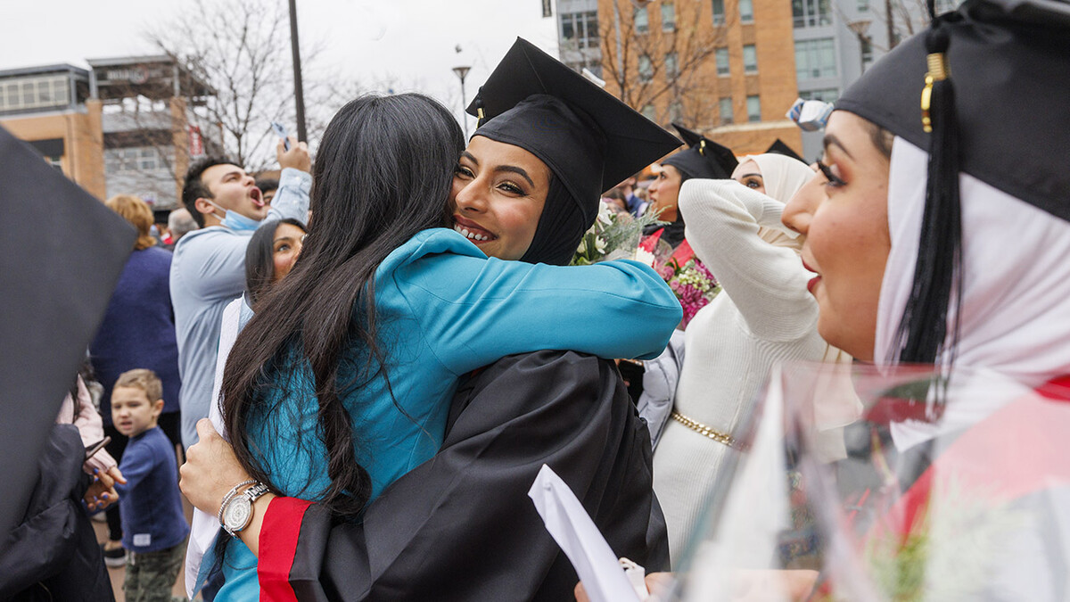 Maathar Al Balushi (center) celebrates her newly earned degree after the undergraduate commencement ceremony Dec. 18 at Pinnacle Bank Arena. She earned a Bachelor of Science in Business Administration.