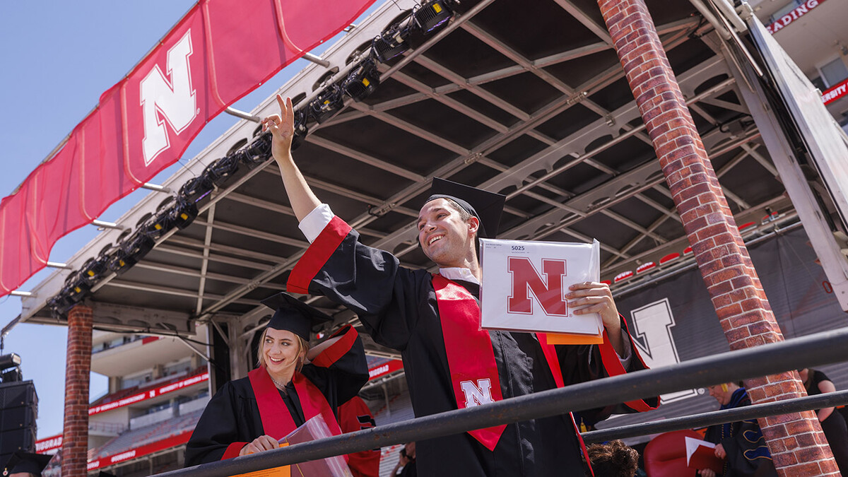 Brett Gaffney waves to his family and friends after receiving his diploma during the undergraduate commencement ceremony May 14 at Memorial Stadium. He earned a Bachelor of Arts from the Hixson-Lied College of Fine and Performing Arts.