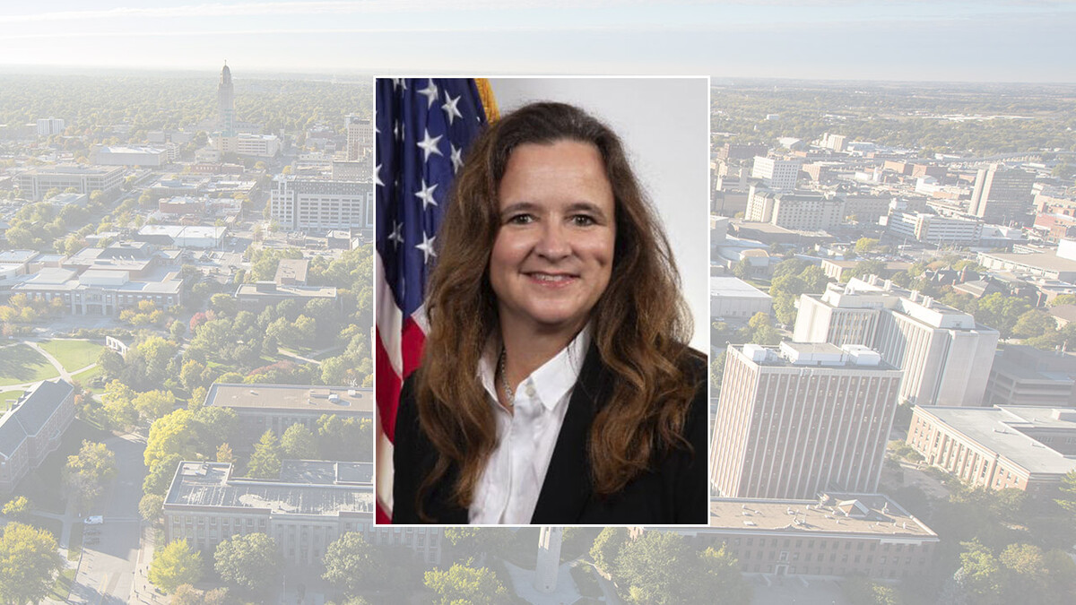 Color photo of Karen St. Germain, over campus and downtown background