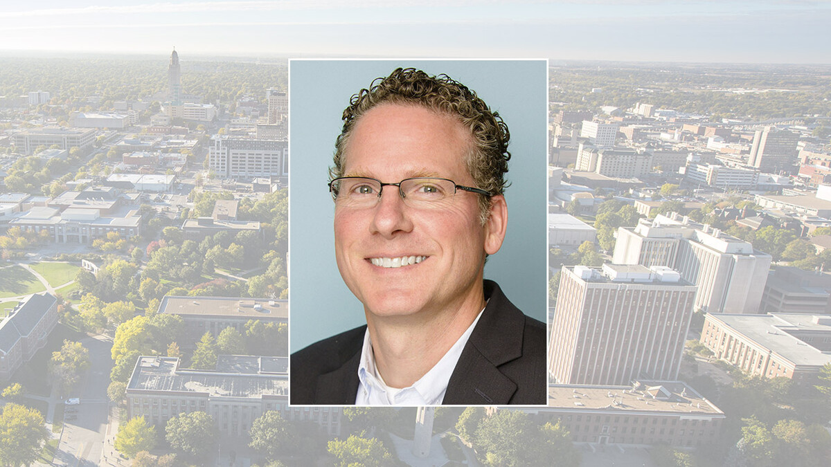 Color portrait of Derek McLean on color campus background