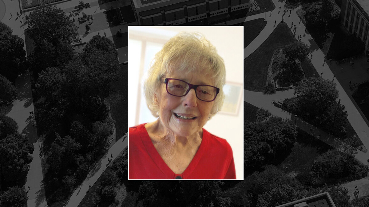 Color portrait of Donna L. Aksamit on black campus background