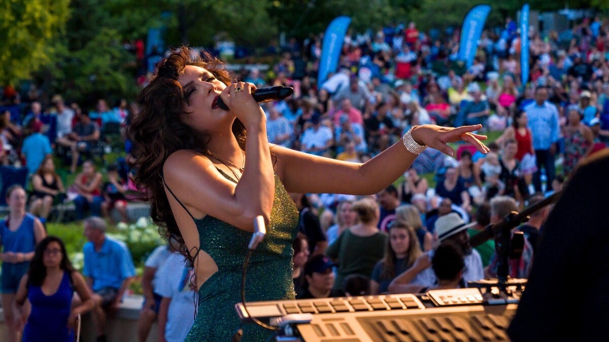 Alexis Arai sings into a microphone.