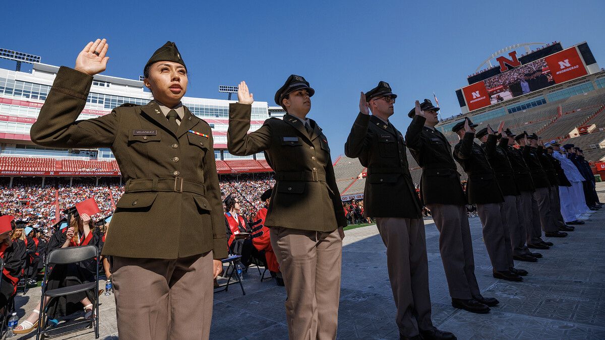 Air Force, Army and Naval ROTC members recite the oath of enlistment during the undergraduate commencement ceremony May 20 at Memorial Stadium.