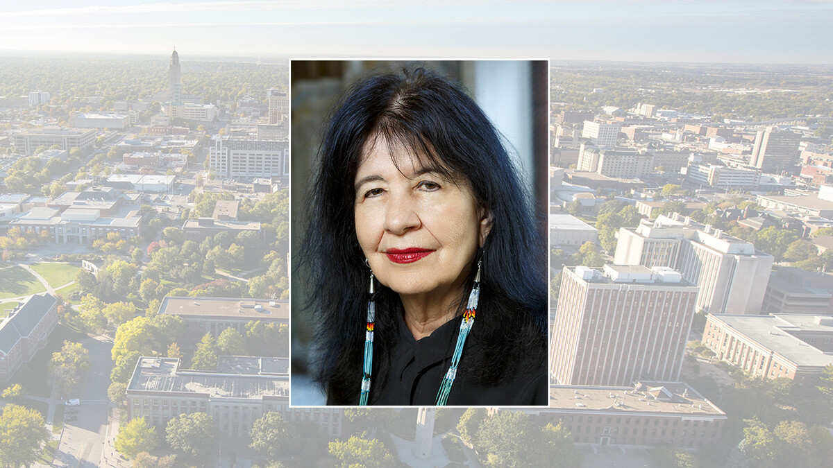 Color photo of Joy Harjo on a color campus background