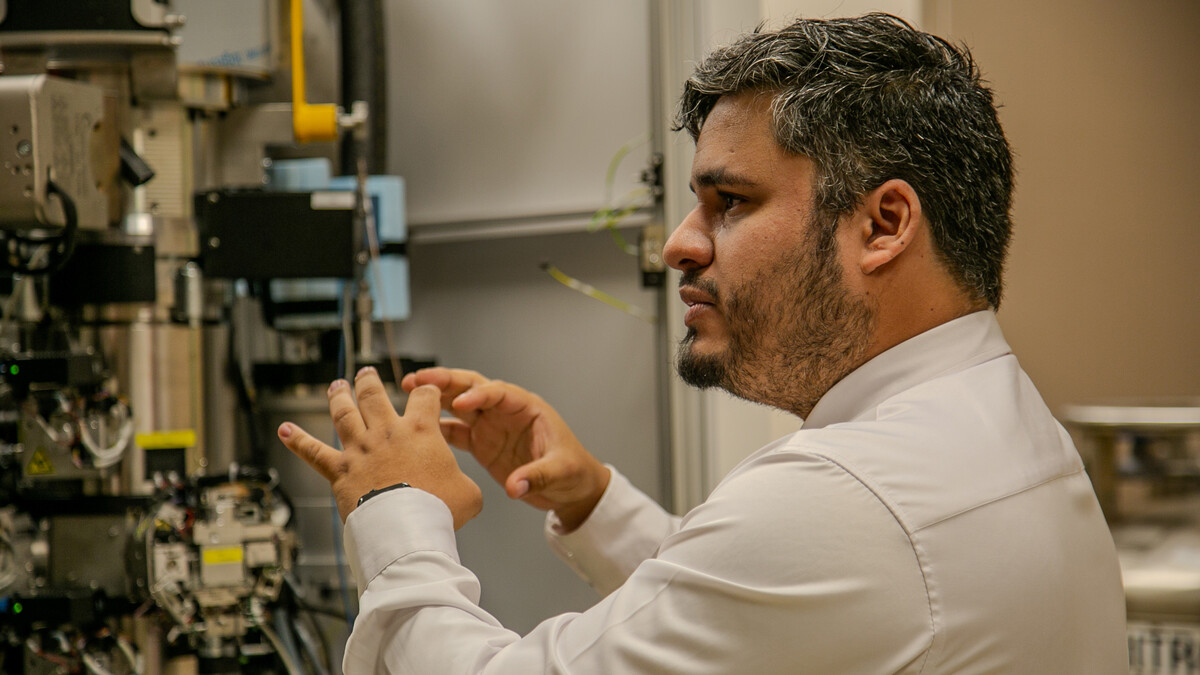 Eduardo Romero Camacho gestures with his hands as he gives a laboratory tour.