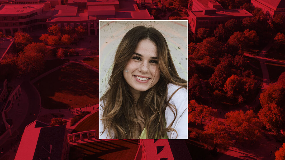 Color portrait of Thursey Cook on a red campus background