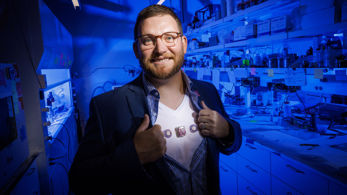 Eric Markvicka, Krohn Assistant Professor of Biomedical Engineering, displays the wearable monitoring device he is helping develop. The device is attached to his undershirt.