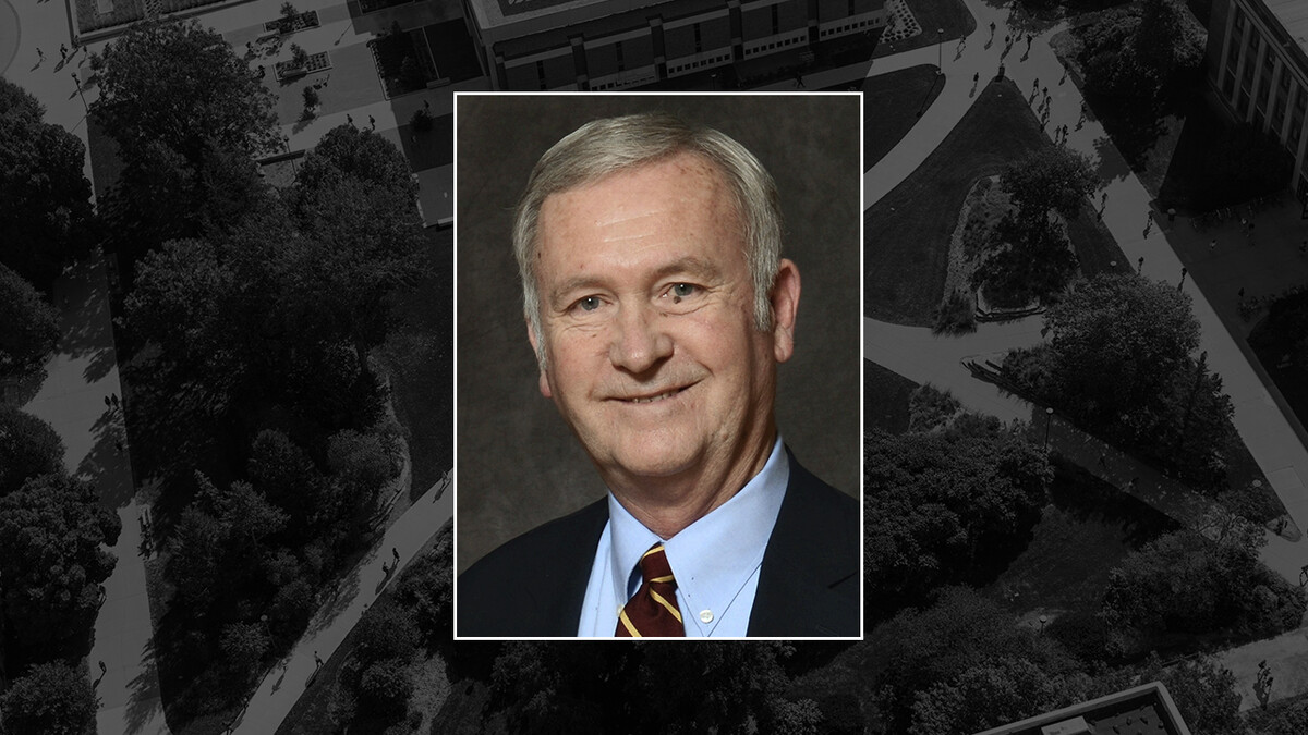 A color portrait of Gerard (Gerry) R. Finnegan Jr. on a black campus background