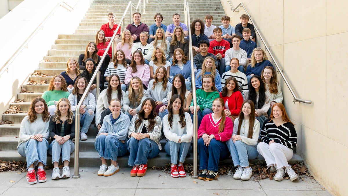 Forty-five students — all new strengths coaches in the University of Nebraska–Lincoln's Clifton Strengths Institute — sit on an outdoor staircase.