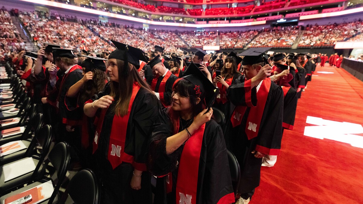 Graduates moves their tassels to the left side of their graduation caps toward the end of the afternoon undergraduate commencement ceremony May 17 at Pinnacle Bank Arena.