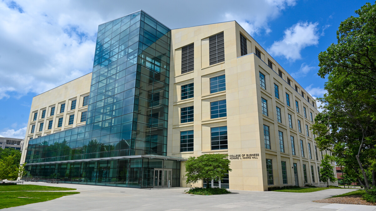 Exterior photo of the south side of Howard L. Hawks Hall on a partly cloudy day.