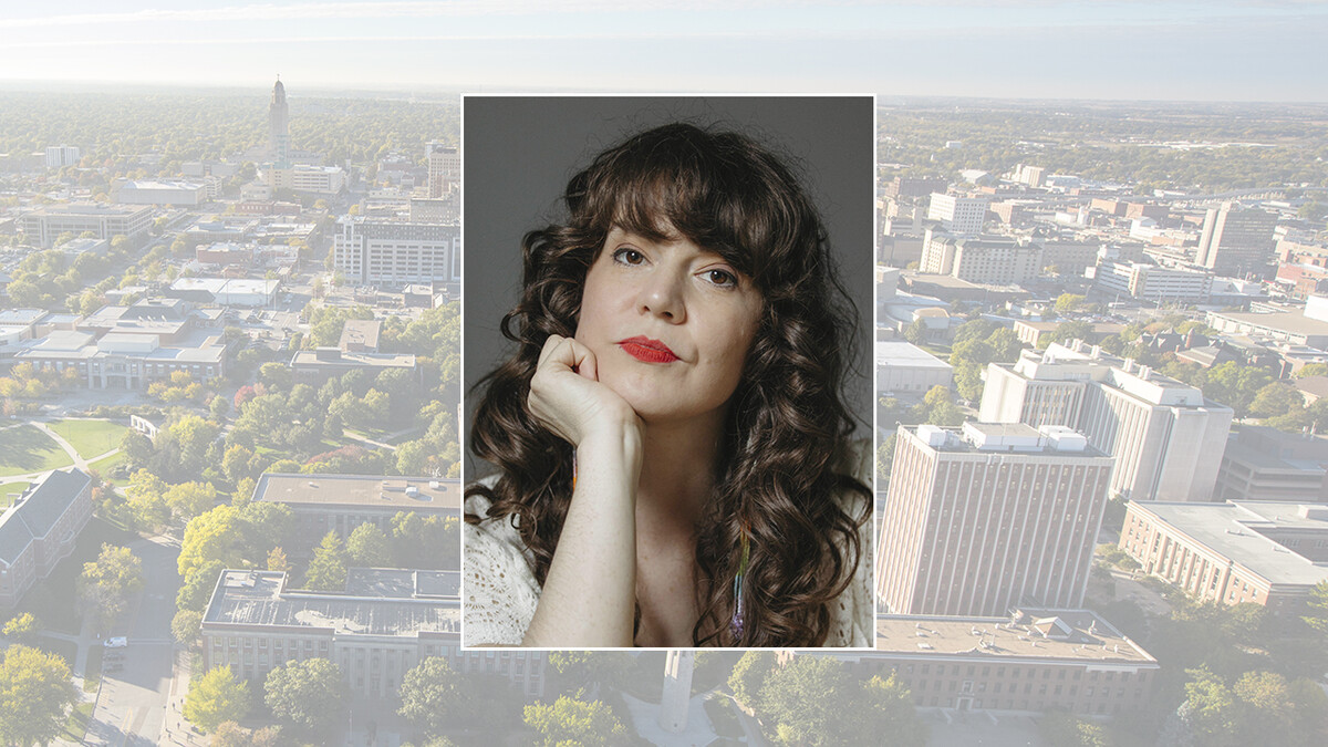 Color portrait of journalist and author Rebecca Nagle on a color campus background.