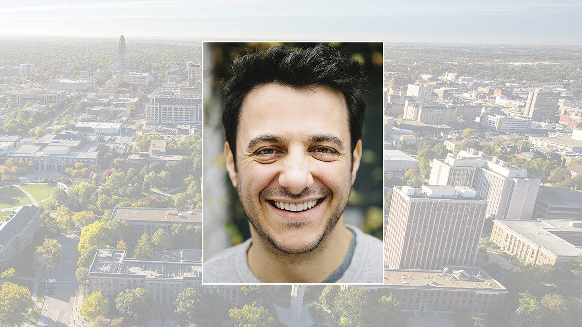 Color portrait of Tim Urban — author, blogger and illustrator — on a color campus background.