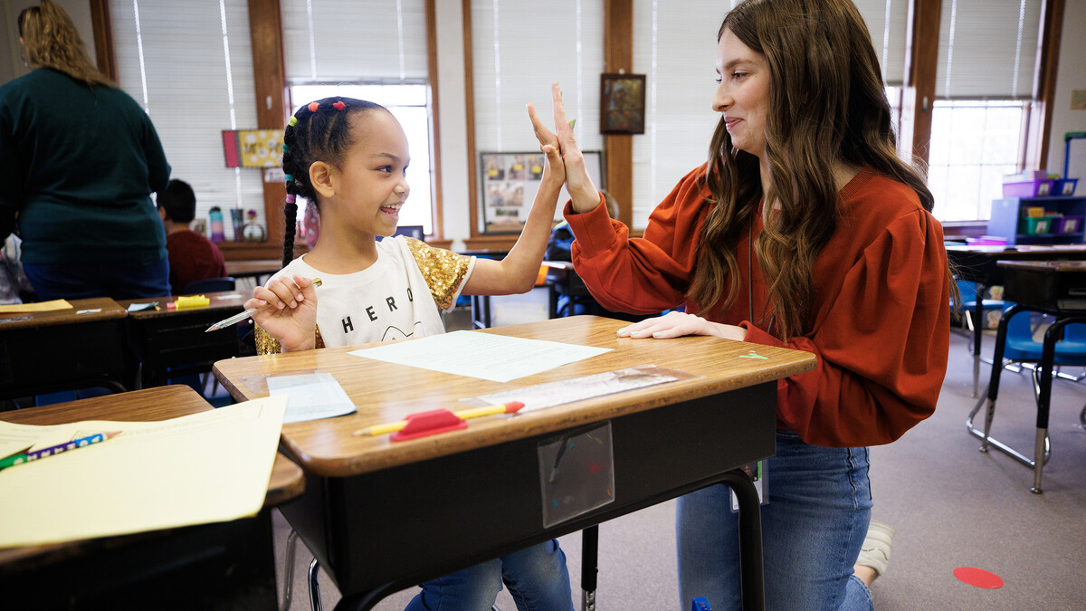 Morgan Twiss, a senior in the Teacher Scholars Academy, works with a second-grader at Elliott Elementary, where she is student-teaching.