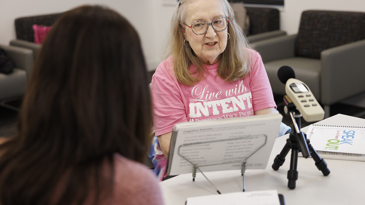 Rhonda Heiserman of Lincoln reads out loud during her clinic session. The instrument measures the decibels of her speech.