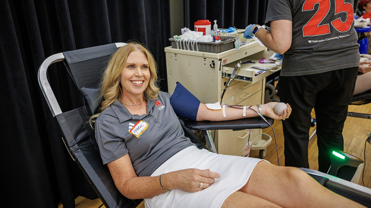 Shelley Zabarowski is seated giving blood in Nebraska Union during Homecoming 2025.
