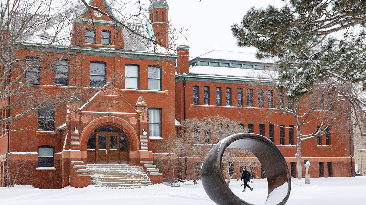 Students walking in snow by Architecture Hall.