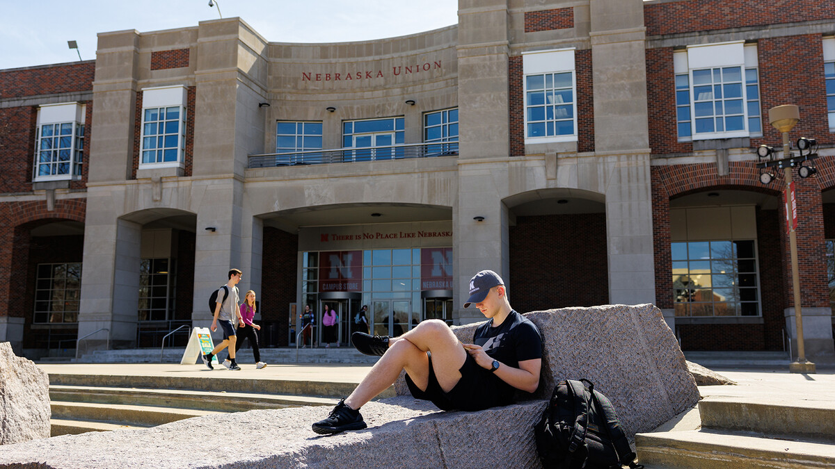 Gavin Kallhoff, a junior construction management major, enjoys the spring weather on March 13 by reading a book while resting on the rocks next to Broyhill Fountain.