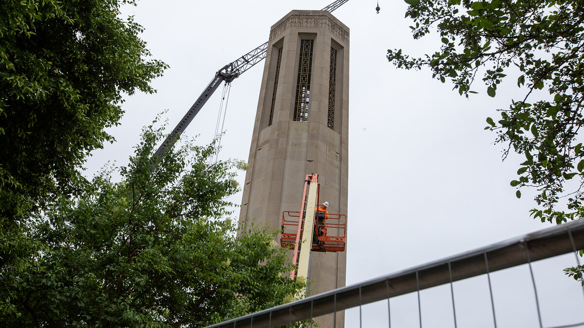 A member of the Kehm Contractors team assesses the stones in the upper levels of Mueller Tower on May 20. The tower is undergoing a restoration this summer repair weather-related damage and improve its durability for future generations of Huskers.