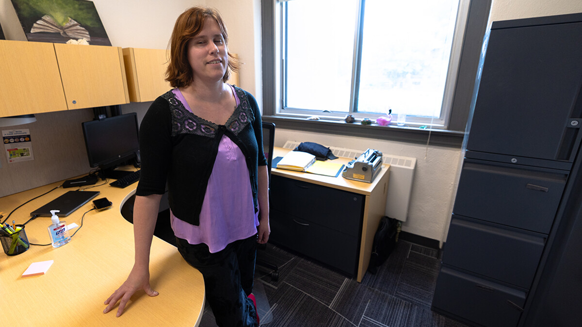 Kelly Coleman stands in her office in Louise Pound Hall, where she works in Services for Students with Disabilities.