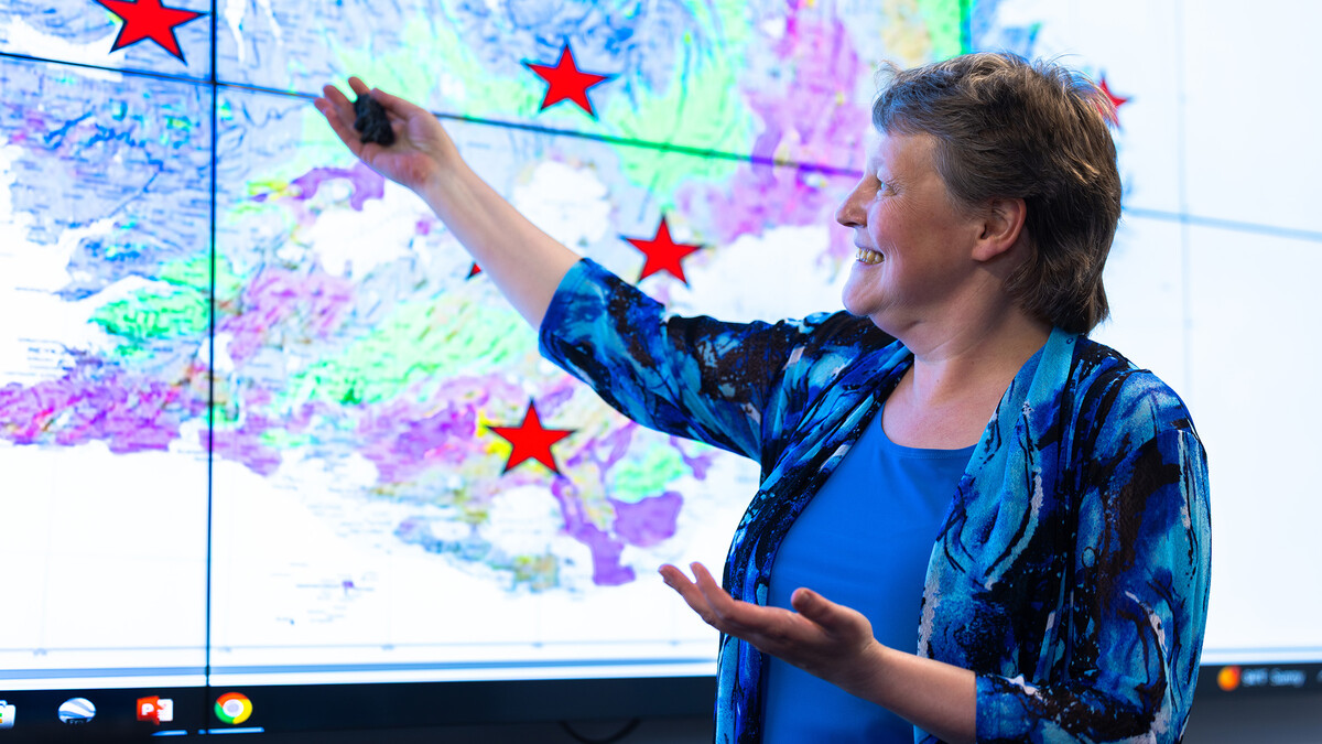 Irina Filina, associate professor of earth and atmospheric sciences, gestures to a graphic of Iceland showing the locations of several volcanoes she wants to visit with students on an upcoming trip.